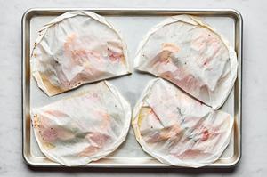 4 Shrimp Scampi En Papillote on a baking sheet just out of the oven
