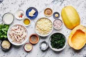 spaghetti squash, chicken, spinach, parmesan, mozzarella, heavy cream, shallot, olive oil and spices in bowls