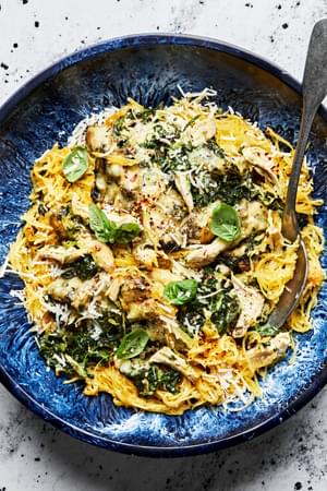 Spaghetti Squash with Creamed Spinach and Chicken topped with parmesan and fresh basil in a bowl