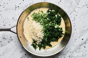 butter, shallot garlic, heavy cream, mustard, spices, spinach, basil and parmesan being cooked in a skillet