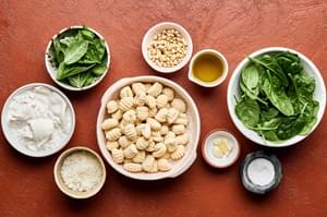 spinach, basil, Parmesan, garlic, pine nuts, salt, olive oil, gnocchi and burrata
laid out in bowls