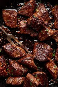 homemade steak bites cooked in slat and olive oil then covered in melted garlic butter and seasoned with pepper
