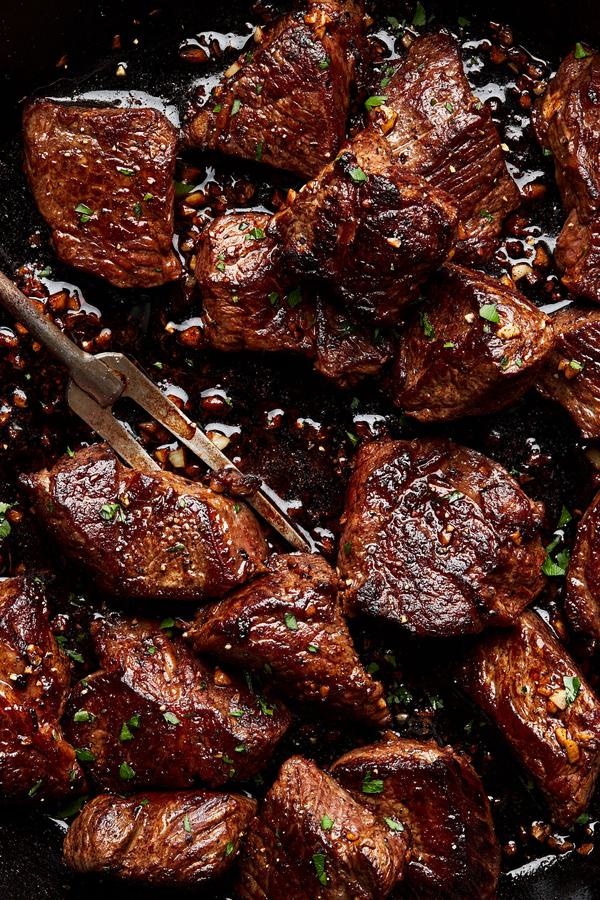 homemade steak bites cooked in slat and olive oil then covered in melted garlic butter and seasoned with pepper