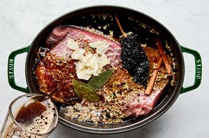 brisket, seasoning, beef stock, water, cinnamon stick, bay leaves, chili, garlic and beer in a dutch oven to make corned beef