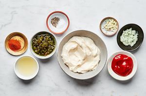 mayonnaise, ketchup, relish, paprika, lemon juice, onion, garlic, salt and pepper in bowls to make thousand island dressing