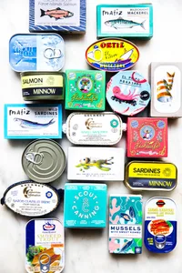 White background with various tin fish packages lined up
