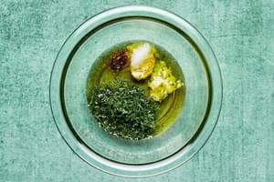vinegar, garlic, dill, olive oil, stone ground mustard, salt and pepper in a mixing bowl to make dressing for tomato salad