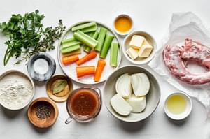carrot, celery, onion, spices, turkey necks, flour, butter, olive oil & chicken bouillon in bowl to make turkey gravy