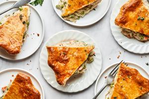 slices of homemade turkey pot pie on plates on the counter made with turkey, vegetables, thyme, salt, pepper and celery seed