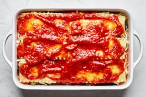 vegetable lasagna in a casserole dish made with layers of mozzarella, vegetables, lasagna sauce, lasagna noodles and marinara