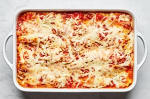 vegetable lasagna in a casserole dish made with layers of mozzarella, vegetables, lasagna sauce, lasagna noodles and marinara