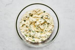 basil, ricotta, Parmesan, eggs, garlic powder, and pepper mixed together in a glass bowl