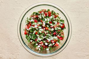 homemade pico de Gallo in a mixing bowl made with Roma tomatoes, White onion, cilantro, Jalapeñoes, Limes and Salt