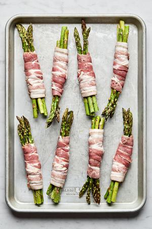 asparagus tossed with olive oil, salt & pepper, in bundles wrapped in bacon on a sheet pan