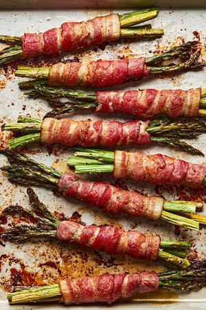 bacon wrapped asparagus just out of the oven on a sheet pan