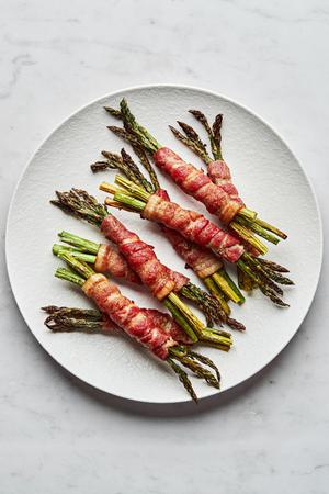 bacon wrapped asparagus on a serving plate