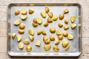 par baked quartered baby potatoes seasoned with olive oil and salt