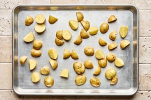par baked quartered baby potatoes seasoned with olive oil and salt