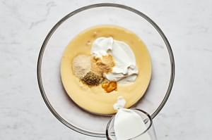 condensed soup, milk, sour cream, bouillon, garlic powder, onion powder, and oregano in a glass bowl