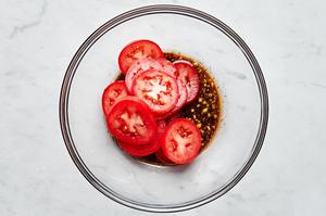 sliced tomatoes tossed in olive oil, balsamic vinegar, garlic, salt, pepper and Italian seasoning in a large mixing bowl