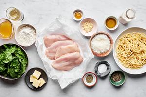 chicken, flour, spices, butter, olive oil, stock, white wine parmesan, spinach, and noodles in prep bowls
