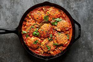homemade chicken marengo topped with fresh parsley in a skillet made with mushrooms, shallots, diced tomatoes and spices