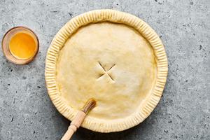 A homemade chicken pot pie with a flaky crust, filled with chicken, vegetables, and creamy sauce