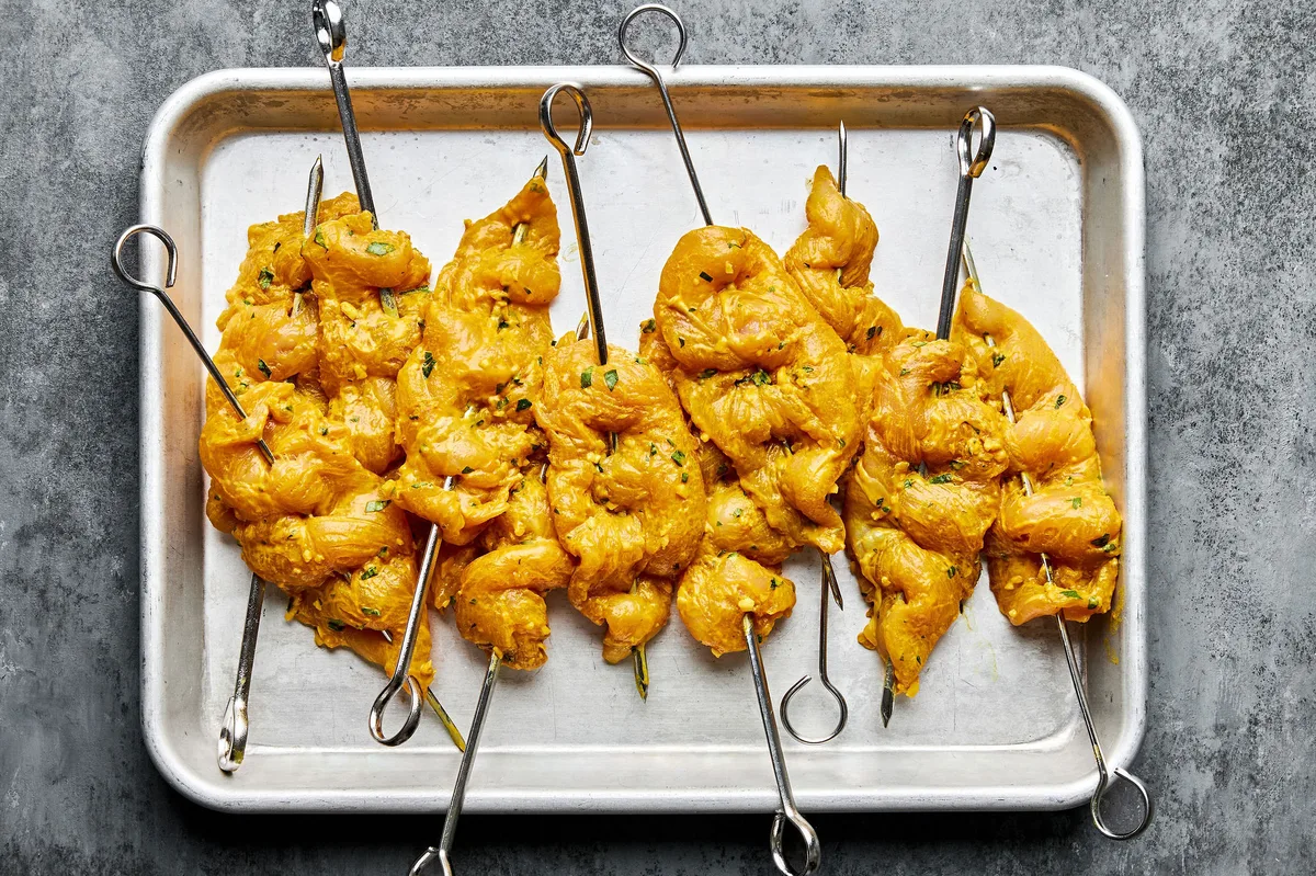 coconut milk turmeric marinaded chicken on skewers