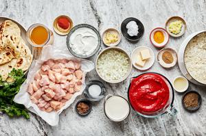 chicken, coconut milk, greek yogurt, spices, butter, onion, crushed tomatoes and chicken stock in prep bowls