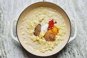 coconut oil, butter, onions and spices in a pot to make tikka masala sauce