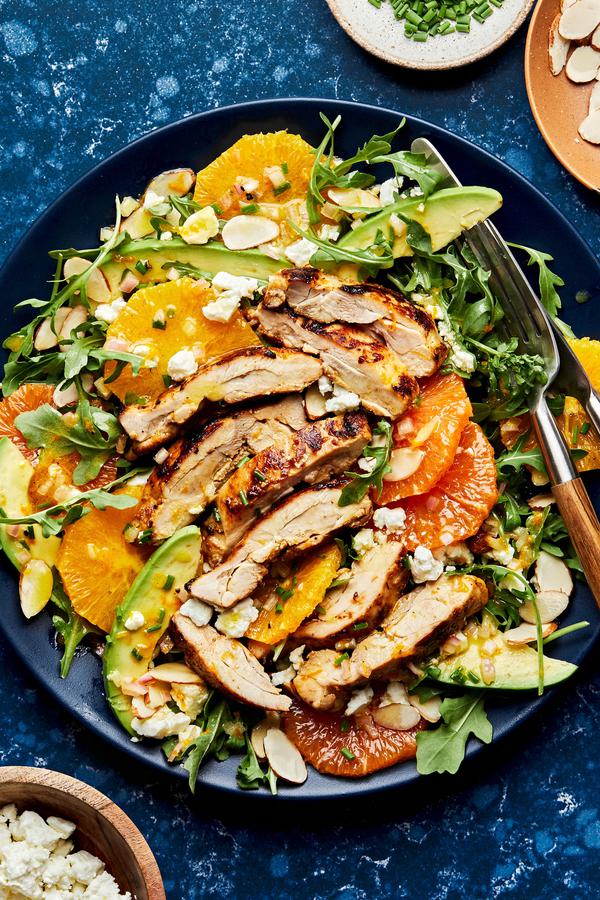 arugula drizzled with citrus dressing topped with chicken, avocado, feta, orange, almonds and chives