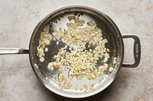 shallots and garlic cooked in a skillet with butter and olive oil