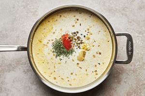 shallots, garlic, cream, stock, rosemary sprigs, lemon zest, lemon juice, mustard, cayenne, and capers in a skillet