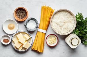fettuccine alfredo ingredients in prep bowls: fettuccine noodles, butter,
Garlic, spices, Heavy cream & Parmesan