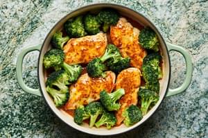 broccoli and chicken with honey mustard curry sauce being cooked in a skillet