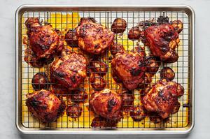 baked chicken thighs seasoned with harissa, olive oil, salt, garlic powder, and onion powder on a baking sheet