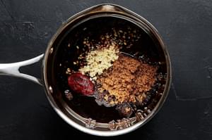 brown sugar, soy sauce, Gochujang, sesame oil, rice vinegar, fish sauce, and garlic in a sauce sauce pan