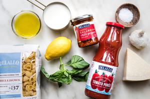 Delallo shellbow noodles, calibrian chilis, tomato puree, olive oil, parmesan, lemon, cream, basil and salt in prep bowls