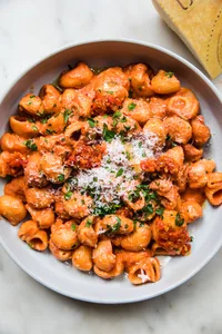 a bowl of homemade lemony Calabrian chili pasta topped with parmesan cheese and fresh parsley