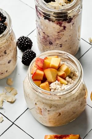 Three jars of overnight oats with various toppings: fruit, chia seeds, jam and coconut