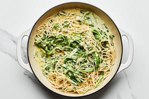 homemade pasta al limone with asparagus made with romano, parsley and basil in a skillet