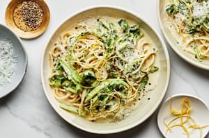 Pasta al Limone with Asparagus topped with pecorino Romano, lemon zest, and pepper in a pasta bowl