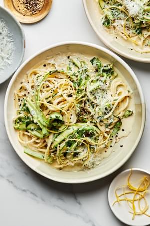 Pasta al Limone with Asparagus topped with pecorino Romano, lemon zest, and pepper in a pasta bowl