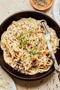 a bowl of pasta with roasted fennel made with garlic, white wine, heavy cream lemon juice & zest. topped with parmesan