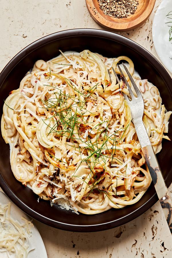 a bowl of pasta with roasted fennel made with garlic, white wine, heavy cream lemon juice & zest. topped with parmesan