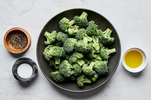 bowls of broccoli, olive oil, salt and pepper to make perfect roasted broccoli