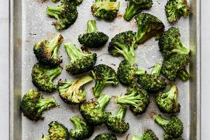 perfect roasted broccoli seasoned with olive oil salt and pepper on a baking sheet
