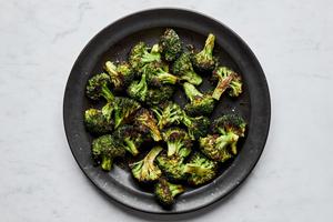 a bowl of perfect roasted broccoli seasoned with olive oil salt and pepper