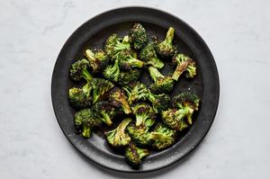 a bowl of perfect roasted broccoli seasoned with olive oil salt and pepper