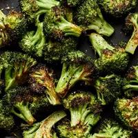 a bowl of perfect roasted broccoli seasoned with olive oil salt and pepper